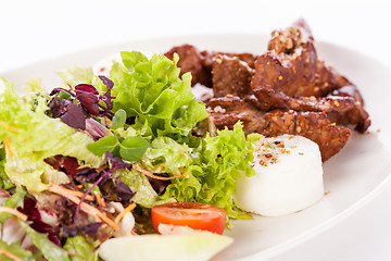 Image showing grilled beef stripes fresh salad and goat cheese