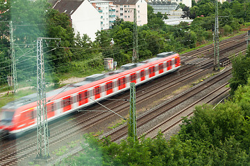 Image showing Fast moving train with red stripe