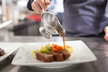 Image showing Chef plating up food in a restaurant