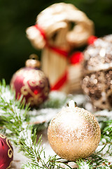 Image showing Gold Christmas ornament on leaves