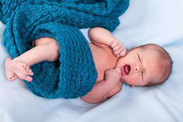 Image showing Small infant wrapped in knitted fabric