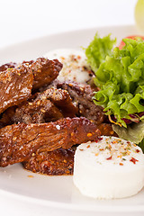 Image showing grilled beef stripes fresh salad and goat cheese