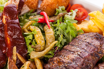 Image showing Platter of mixed meats, salad and French fries