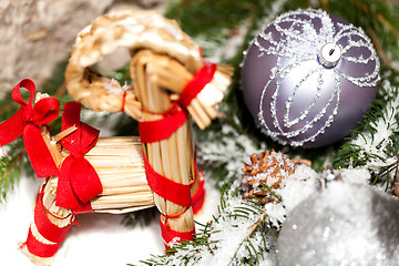 Image showing Silver Christmas bauble on a tree with snow