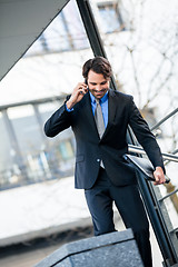 Image showing Businessman listening to a call on his mobile