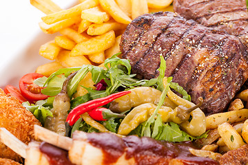 Image showing Platter of mixed meats, salad and French fries