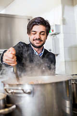 Image showing Chef cooking a vegetables stir fry over a hob