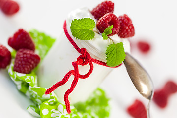 Image showing Raspberries and yoghurt or clotted cream