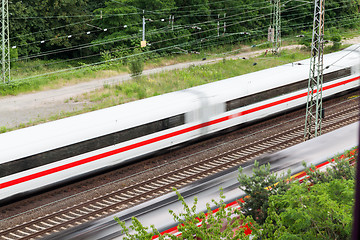 Image showing Fast moving train with red stripe