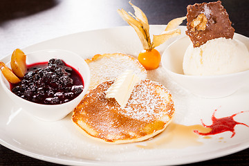 Image showing tasty sweet pancakes with vanilla icecream and topping