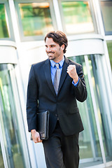 Image showing Motivated businessman punching the air