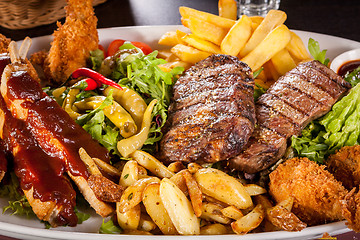 Image showing Platter of mixed meats, salad and French fries