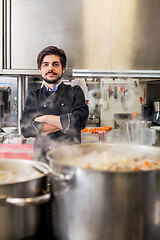 Image showing Chef cooking a vegetables stir fry over a hob