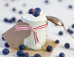 Image showing Jar of clotted cream or yogurt with blueberries