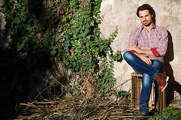 Image showing Male model sitting with legs crossed