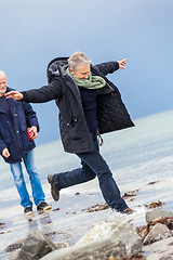 Image showing happy elderly senior couple walking on beach