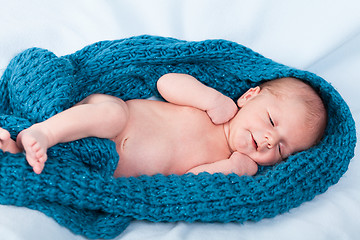 Image showing Small infant wrapped in knitted fabric