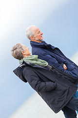 Image showing happy elderly senior couple walking on beach