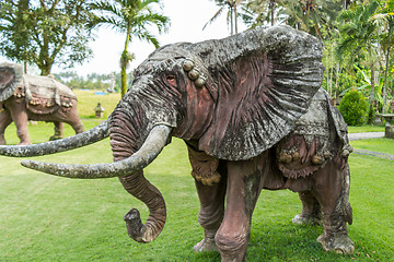 Image showing Elephant statue standing on a lawn at a park