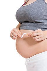 Image showing Pregnant woman breaking a cigarette in two