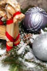 Image showing Silver Christmas bauble on a tree with snow