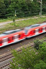 Image showing Fast moving train with red stripe