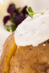 Image showing Baked jacket potato with sour cream sauce