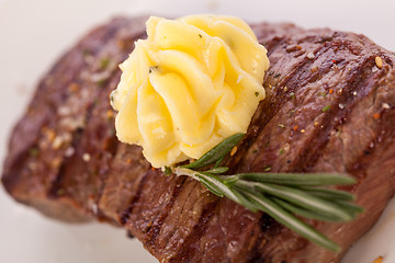 Image showing Grilled beef steak topped with butter and rosemary