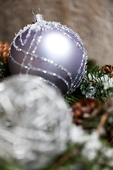 Image showing Silver Christmas bauble on a tree with snow