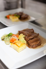 Image showing Chef plating up food in a restaurant