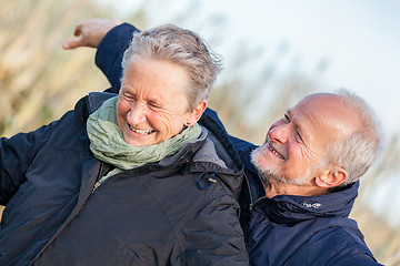 Image showing Elderly couple embracing and celebrating the sun