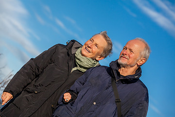 Image showing happy elderly senior couple walking on beach