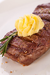 Image showing Grilled beef steak topped with butter and rosemary