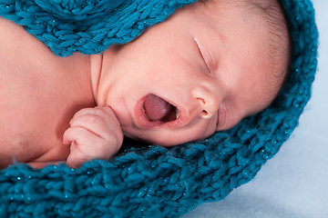 Image showing Small infant wrapped in knitted fabric