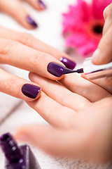 Image showing Woman having a nail manicure in a beauty salon