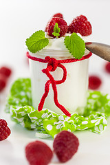 Image showing Raspberries and yoghurt or clotted cream