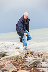 Image showing happy elderly senior couple walking on beach