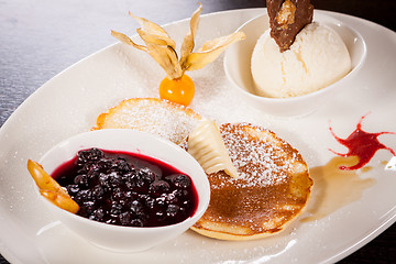 Image showing tasty sweet pancakes with vanilla icecream and topping