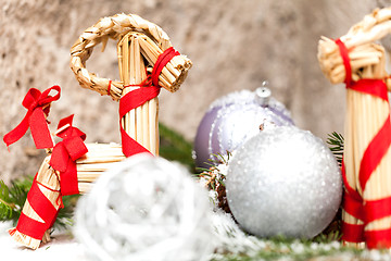 Image showing Silver Christmas bauble on a tree with snow