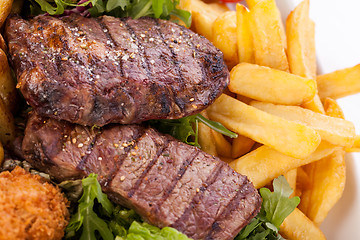 Image showing Platter of mixed meats, salad and French fries