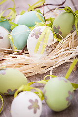 Image showing Colourful green Easter eggs in straw