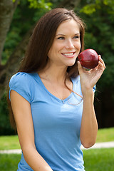Image showing Happy Woman in the Park with Red Delicious Apple