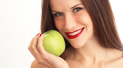 Image showing Green Granny Smith Apple Held Close to Attractive Woman Face