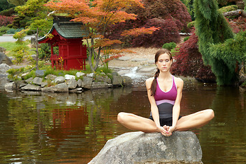 Image showing Healthy woman practices Yoga in beautiful Yoga Pond