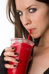 Image showing Girl Sipping on Red Food Fruit Smoothie