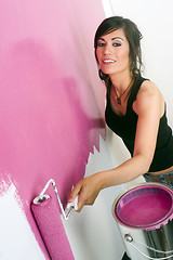 Image showing Young Adult Home Maker Paint the Walls Pink with Roller