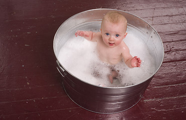 Image showing Infant Taking Bubble Bath in Big Round Galvanized Tub