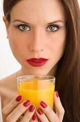 Image showing Healthy Drink Beautiful Woman Looks at Camera Holding Juice