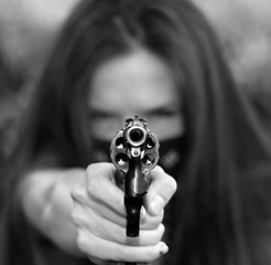 Image showing Masked Woman Pointing Gun Right at Camera