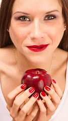 Image showing Manicured Female Hands Holding Red Delicious Apple